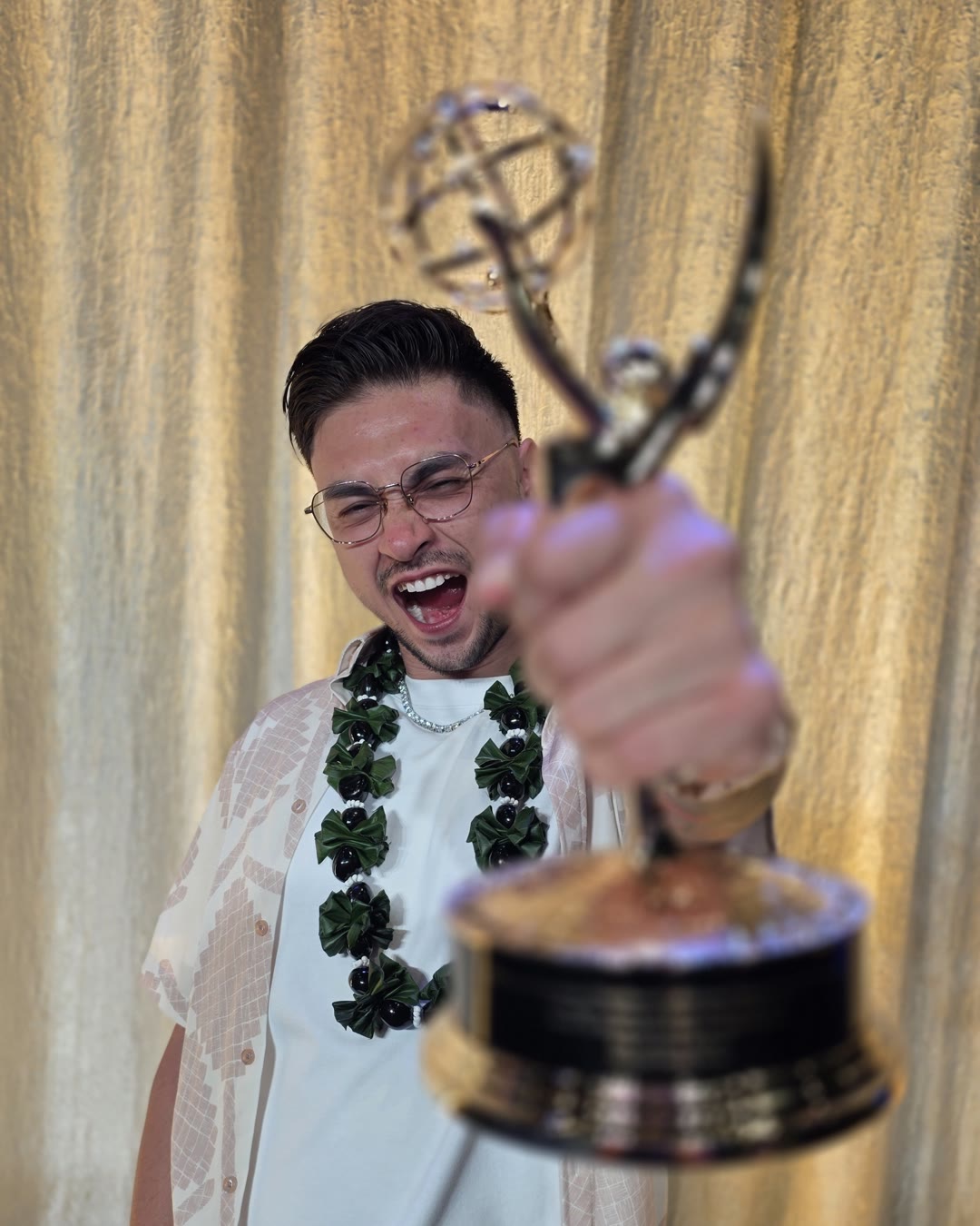 Zak Covert holding his Emmy Award